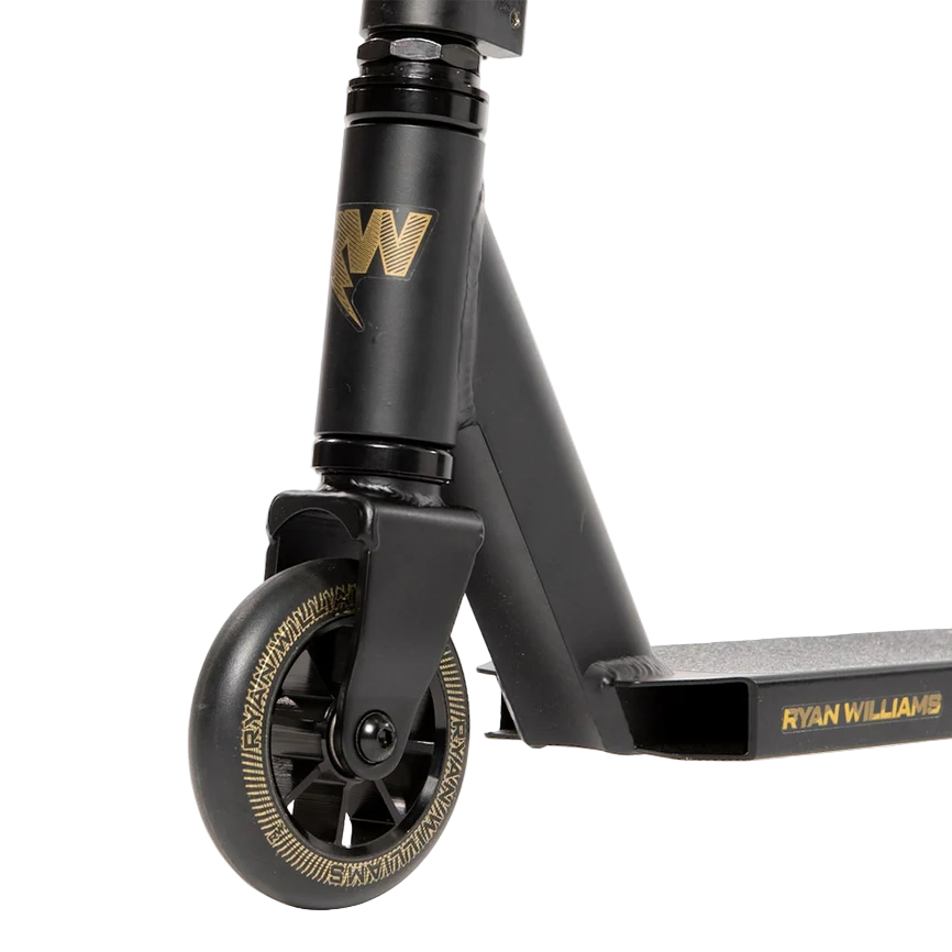 Close-up of the front wheel and deck of the Nitro Circus Ryan Williams Junior Replica 2025 Complete Stunt Scooter in black, showing gold accents and "Ryan Williams" details.