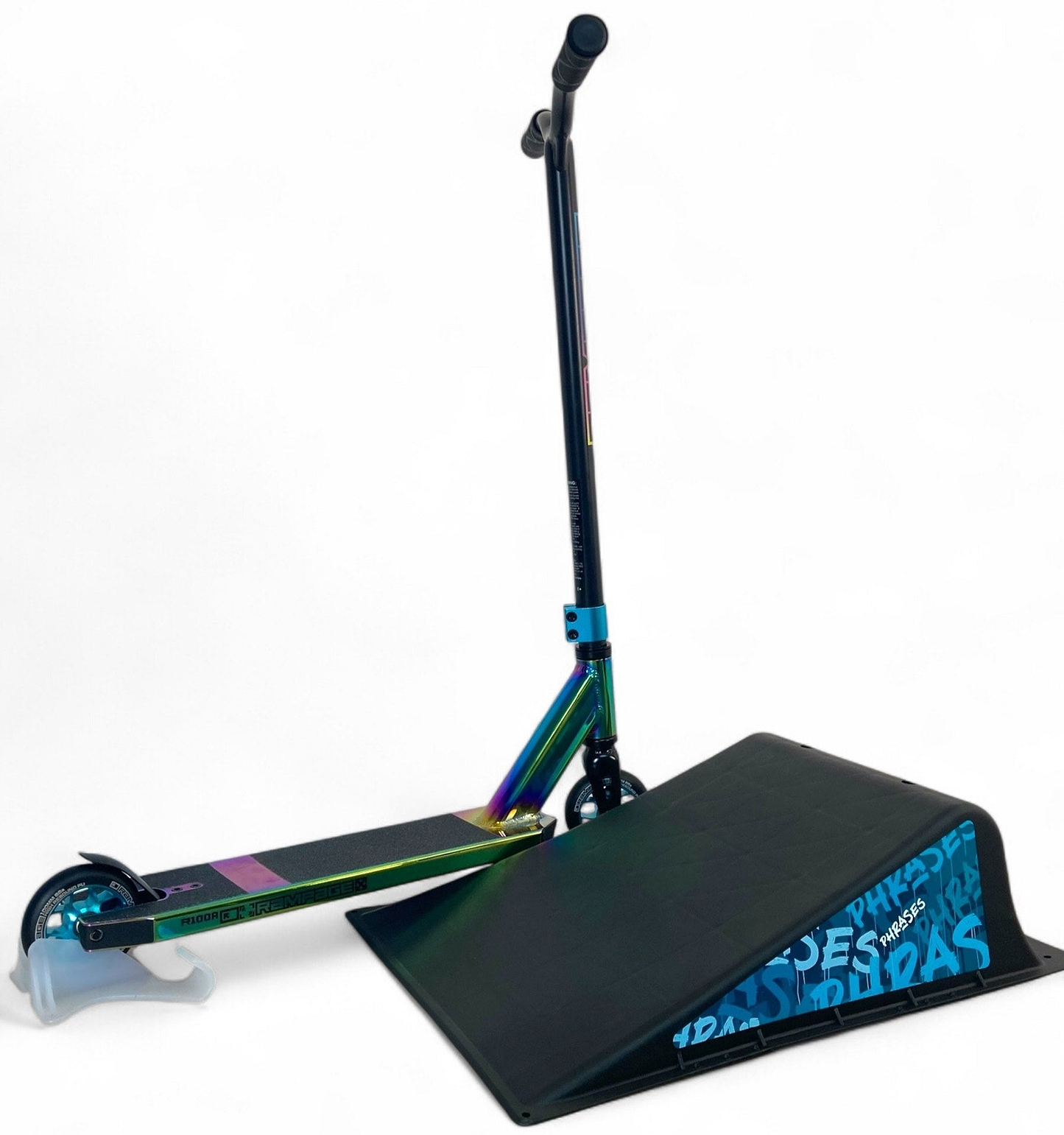 A colorful stunt scooter balances its front wheel on the Phrases One Way Kicker Skate Ramp by Phrases, featuring blue text on the side, set against a plain white background.