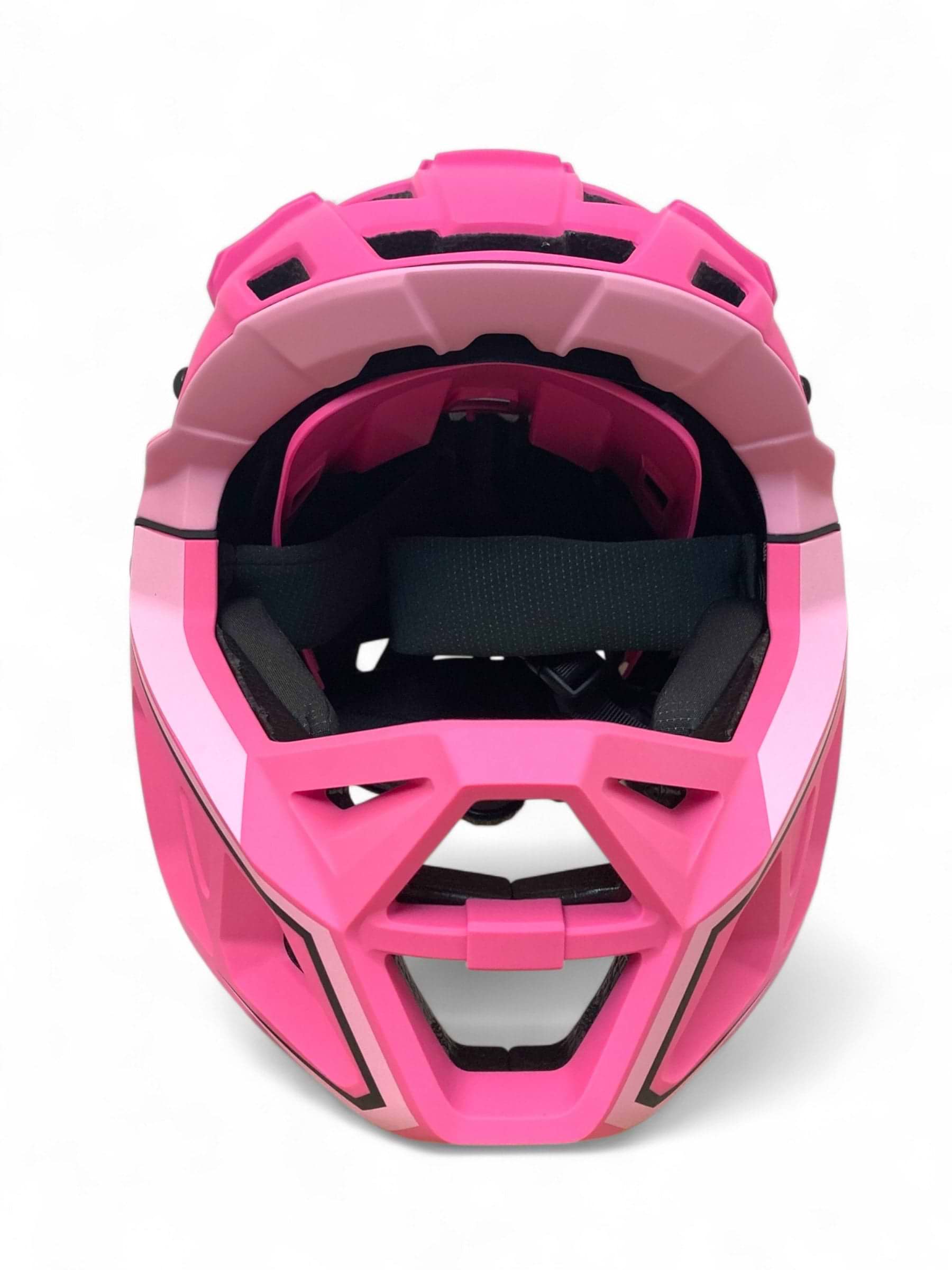 The Revvi Kids Full Face MTB Helmet in bright pink features black interior padding and ventilation openings, shown front-facing against a white background. Brand: Revvi.