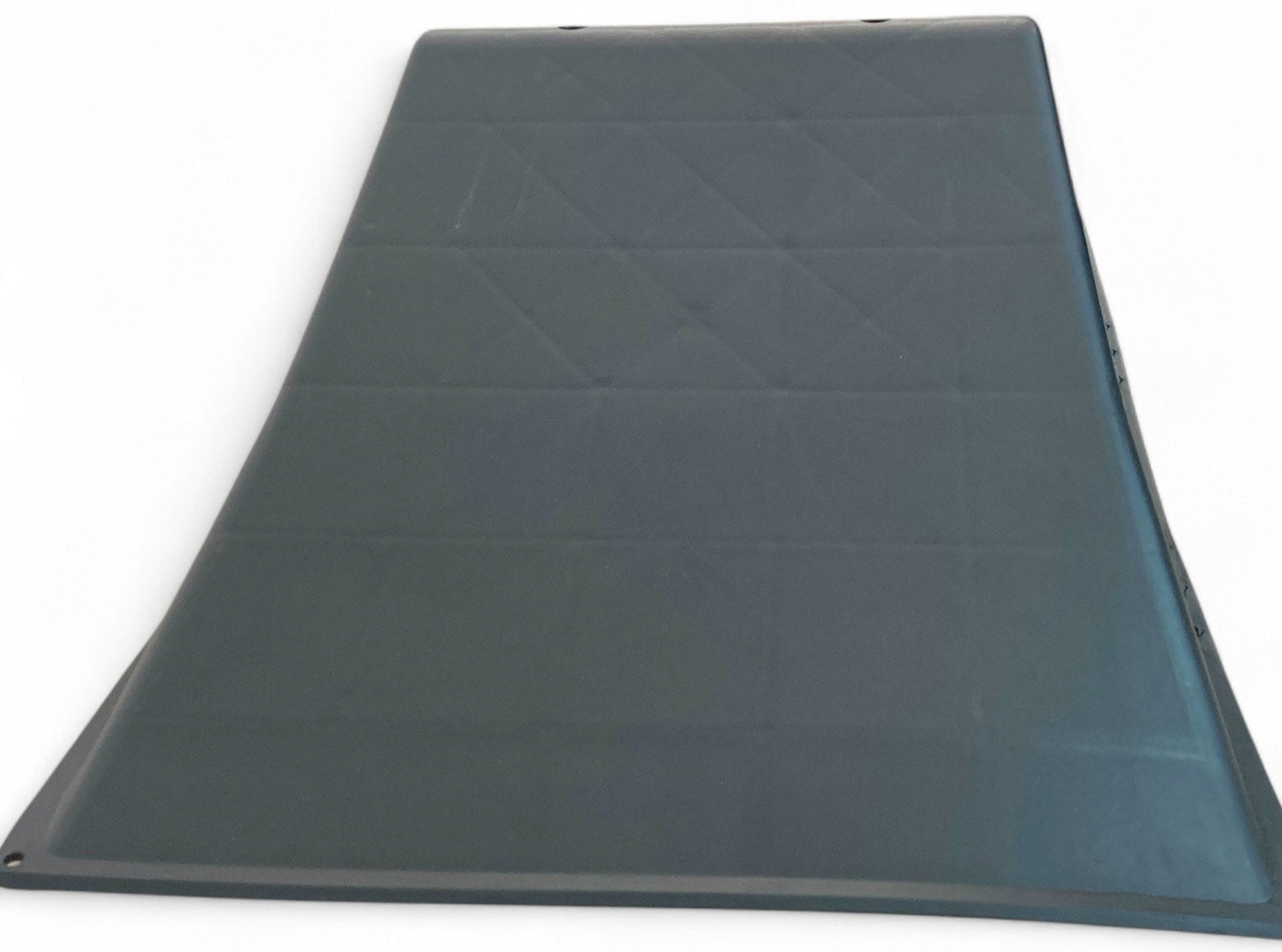 A flat, dark rectangular mat with raised edges and a quilted pattern, perfect for beginner skateboarders to use with the Phrases One Way Kicker Skate Ramp by Phrases, shown on a white background.
