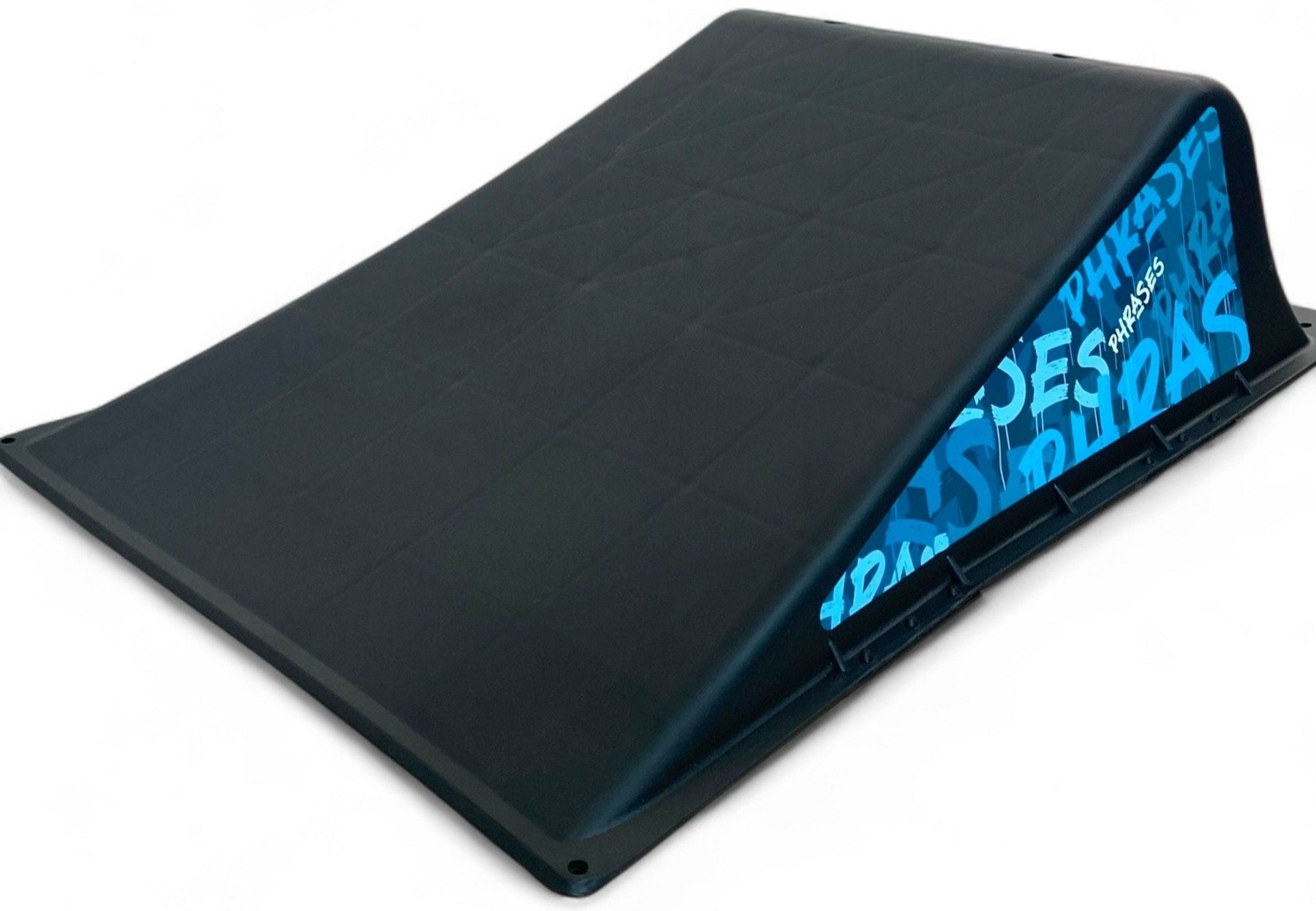 The Phrases One Way Kicker Skate Ramp by Phrases features a black portable design with a textured surface and blue graffiti-styled inner sides, shown on a white background—perfect for beginner skateboarders.