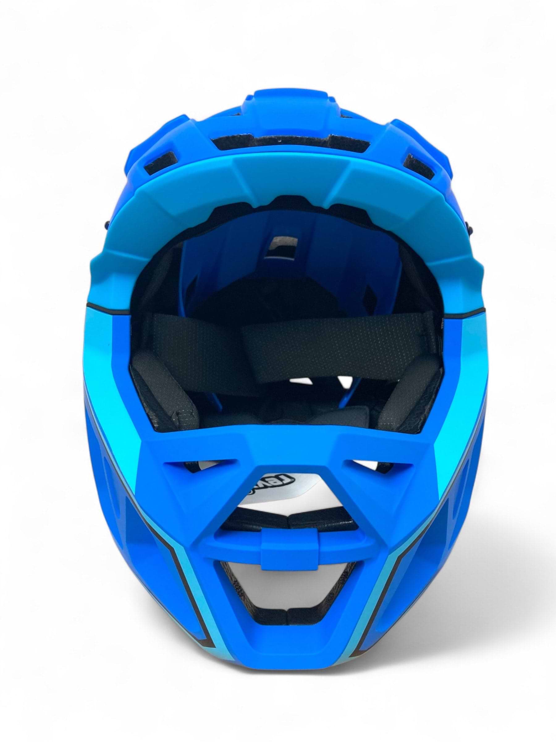 The Revvi Kids Full Face MTB Helmet in Blue by Revvi is shown from the front, displaying its open face, black padding, and geometric vents against a white background—perfect as an adjustable child bike helmet.