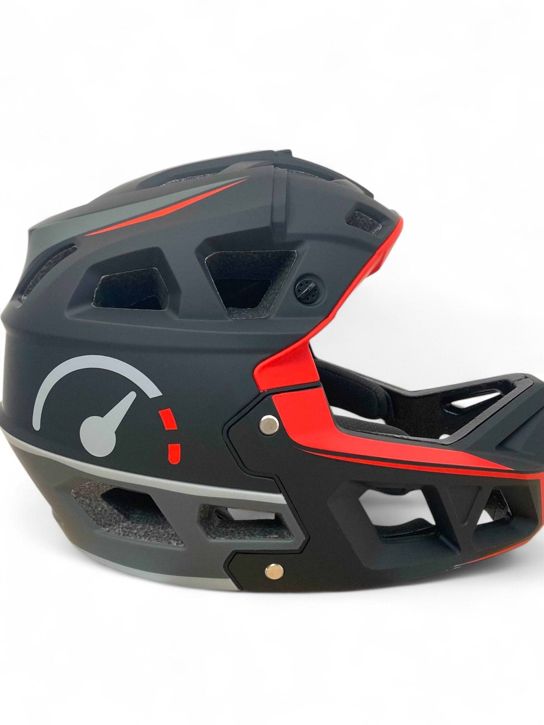 The Revvi Kids Full Face MTB Helmet in matte black by Revvi features a red speedometer graphic, adjustable fit, open ventilation sections, and is displayed against a plain white background.