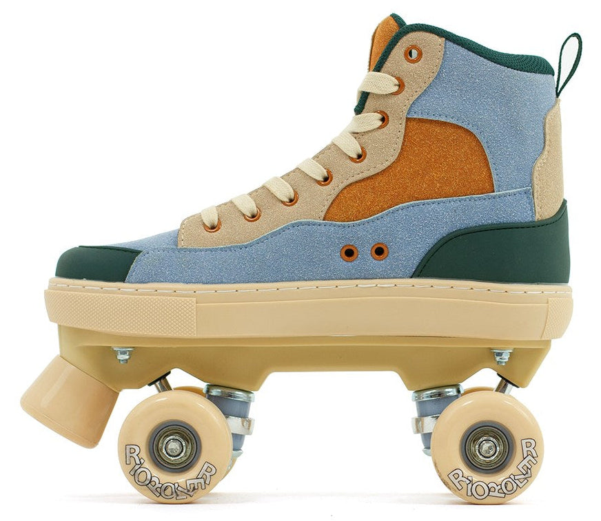The Rio Roller Beats Quad Roller Skates by Rio Roller feature a high-top boot in blue and tan with beige laces, cream wheels and sole. Vegan friendly and retro-styled, these durable skates combine style and performance, seen here from the side.