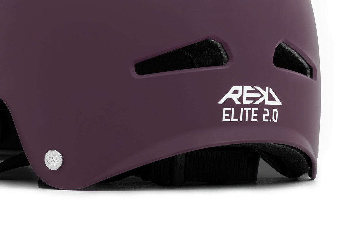 Close-up of a peach/purple REKD Elite 2.0 Skate/Scooter Helmet featuring ventilation holes, a silver screw, and the white REKD Elite 2.0 logo on the side.