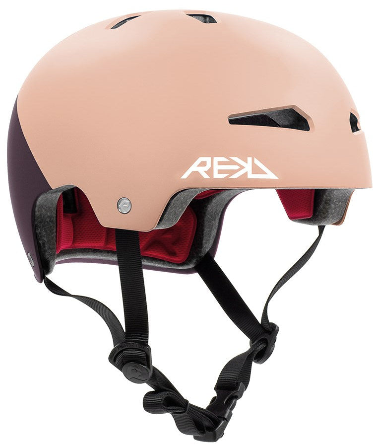 The REKD Elite 2.0 Skate/Scooter Helmet in Peach/Purple features black adjustable straps, red inner padding, ventilation holes, and a white REKD logo. This certified helmet is stylish and safe for any ride.