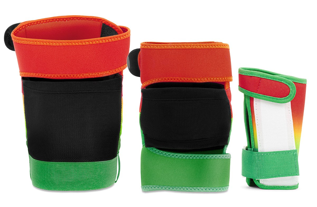 Three vibrant REKD Shield Triple Skate Protection Pad Sets in Fade Orange/Green are displayed upright, designed for action sports protection. Featuring secure Velcro closures and versatile wrist guards, these pads are shown from multiple angles against a white background.