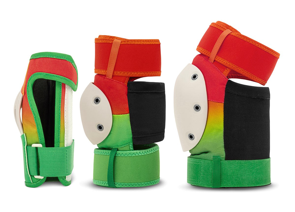 Three vibrant wrist guards from the REKD Shield Triple Skate Protection Pad Set in Fade Orange / Green offer action sport protection with green, red, and black fabric accented by white hard plastic shields and adjustable straps. Presented from multiple angles on a white background, these REKD wrist guards highlight both their colorful style and durable design.