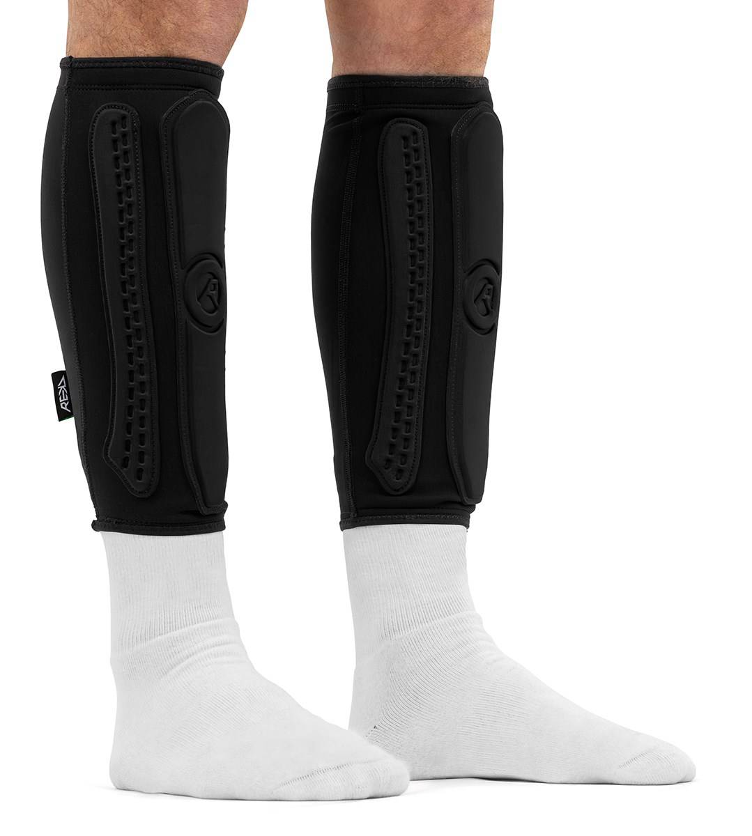 REKD Energy Covert Long Shin Skate Protection Guards worn over white socks.