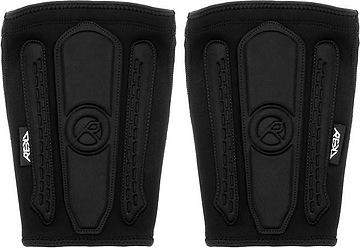 A pair of black REKD Energy Covert Short Shin Skate Protection Guards featuring vertical padding and circular logos on the front for slim impact protection.