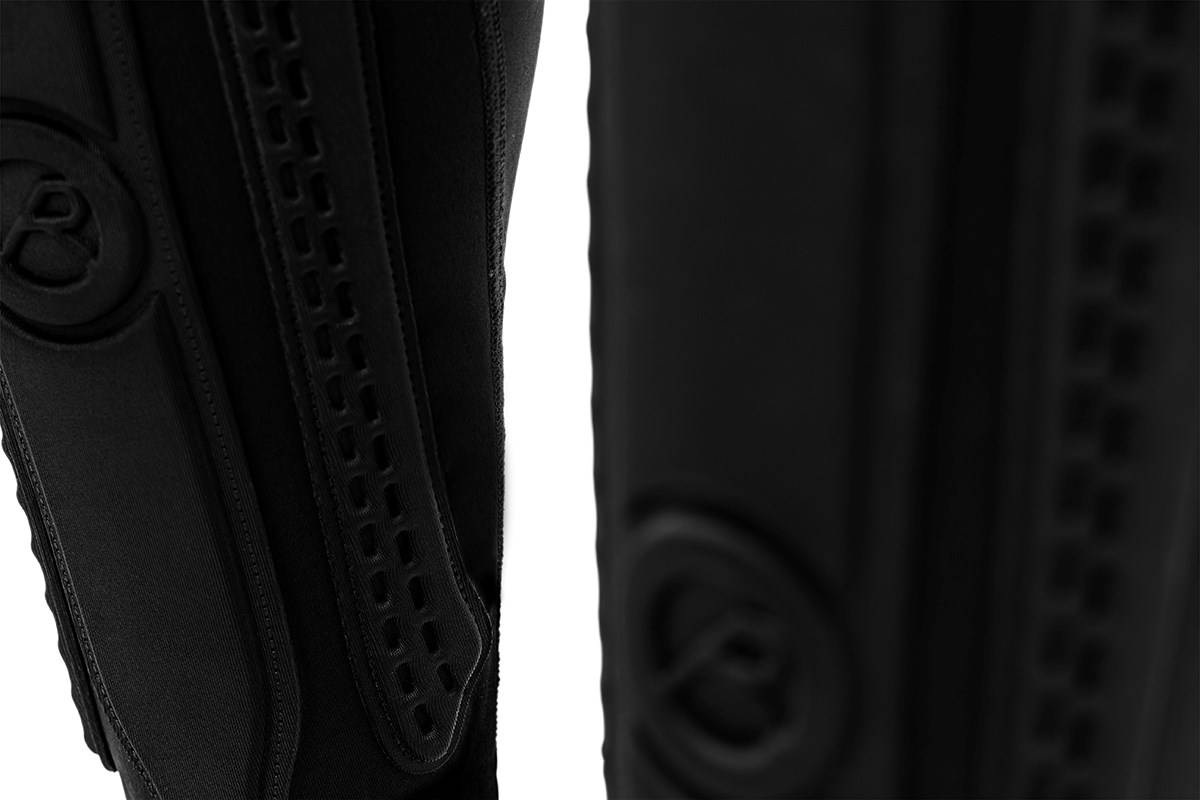 Black REKD Energy Covert Long Shin and Ankle Skate Protection Guards with molded padding and perforated ventilation strips for BMX protection.