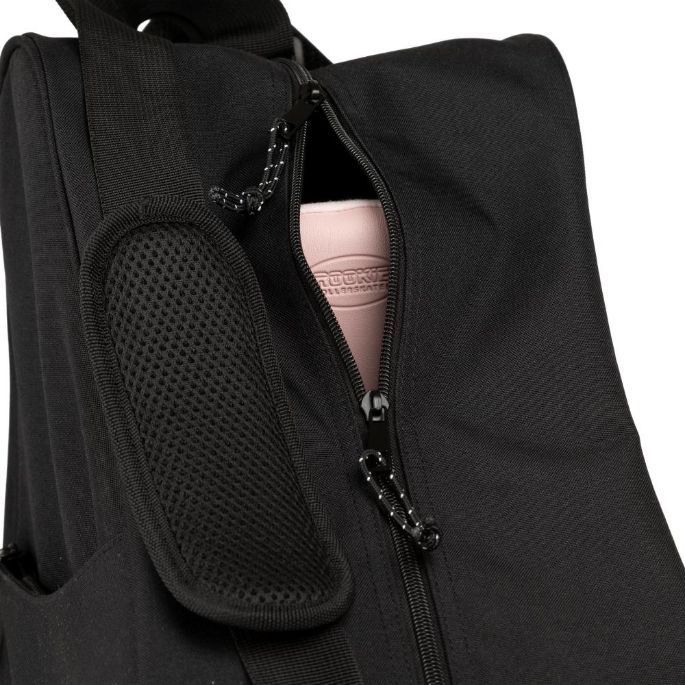 A close-up of the Rookie Classic 78 Skate Bag in black reveals a partially unzipped compartment, with a pink item labeled "CROCKETT" visible inside. The padded, textured shoulder strap on the left side of the bag—crafted by Rookie—ensures comfortable carrying for your skates wherever you go.
