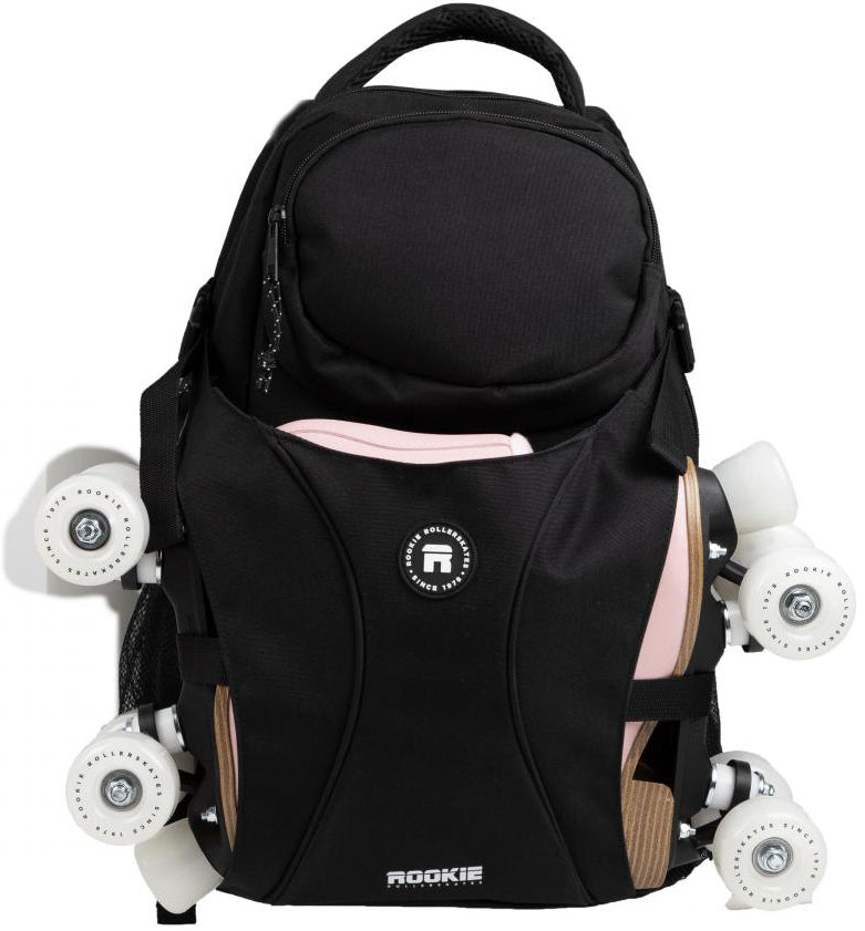 A Rookie Skatepack Classic 78 25L Backpack in black by Rookie is shown with white roller skates featuring light pink accents attached to its sides. The backpack includes a rounded top handle and visible front zippers.