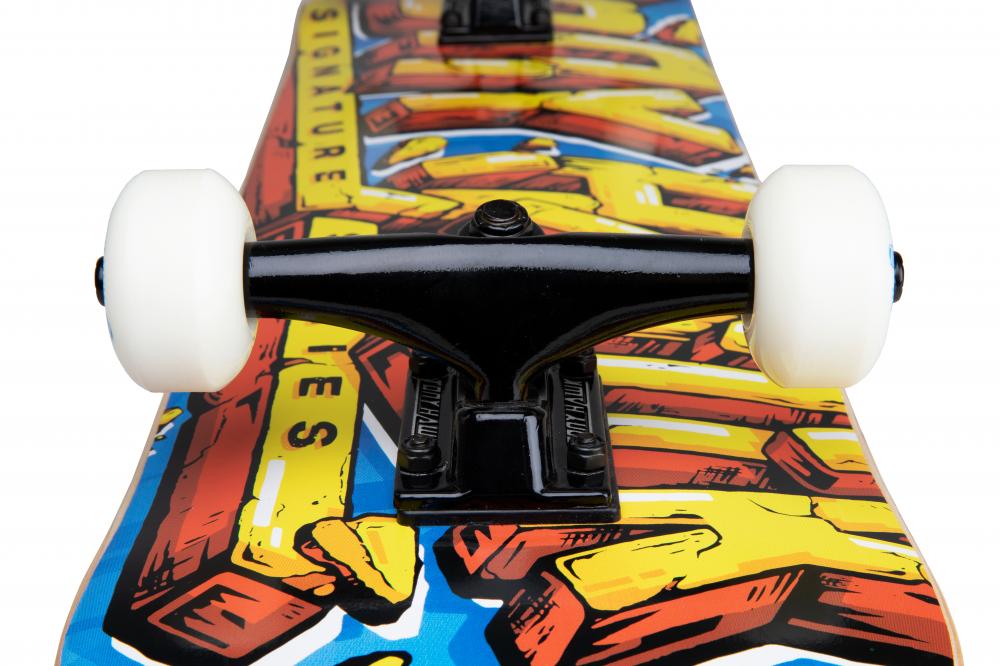 Close-up of the Tony Hawk 540 Series Smash Complete Skateboard’s black trucks and white wheels mounted on a hardrock maple deck featuring bold, colorful, graffiti-style graphics. Deck size: 7.75″ x 31″.
