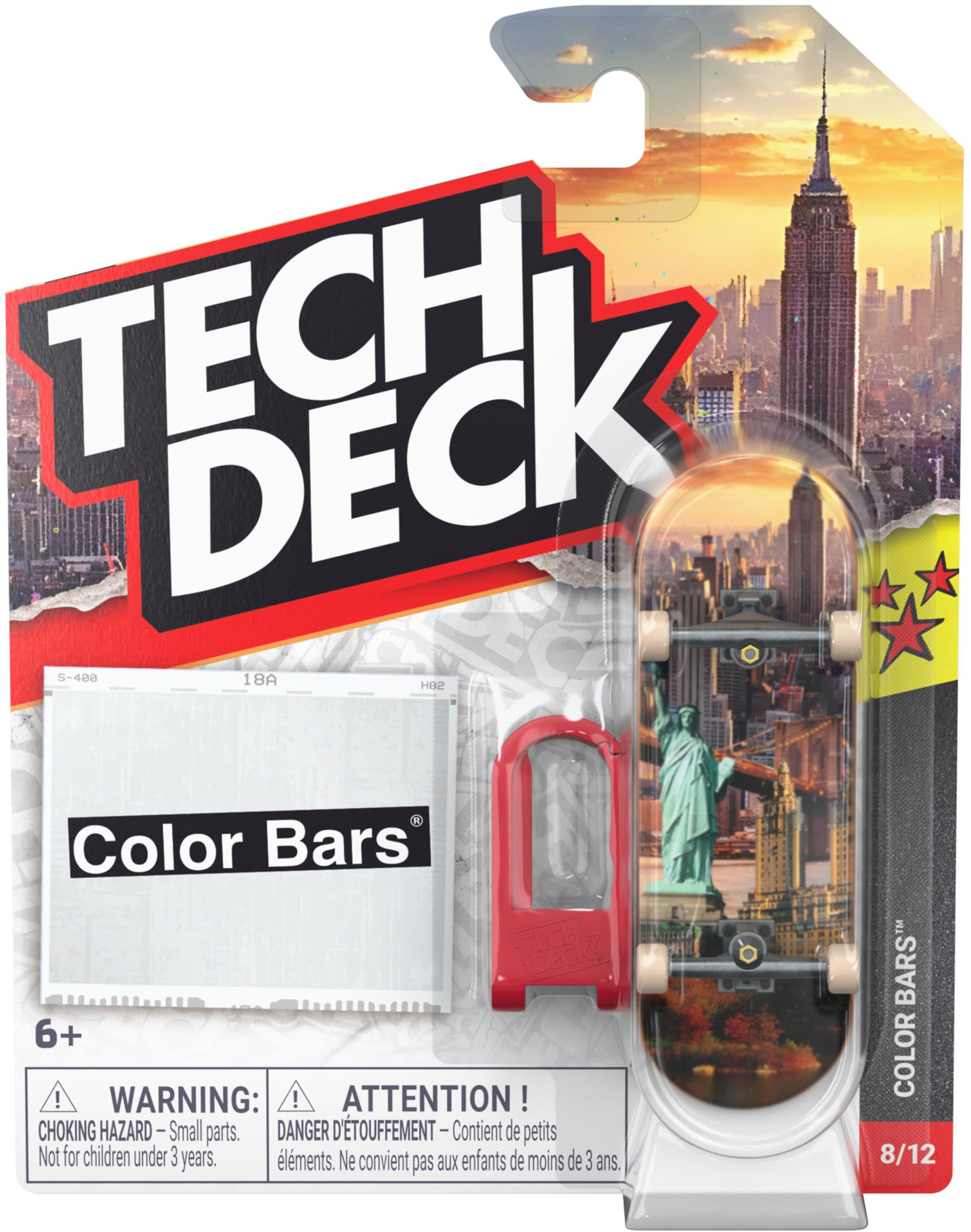 A Tech Deck 96mm M61 Fingerboard - Color Bars featuring a New York City cityscape graphic, packaged with a small red plastic tool in a cardboard blister pack.
