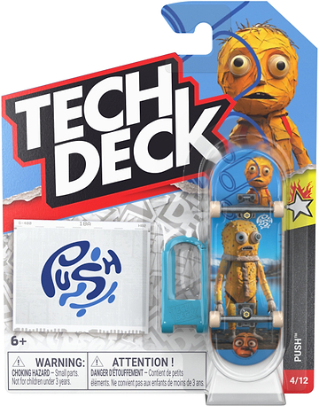 Tech Deck 96mm M61 Fingerboard - Push featuring a cartoon character with large eyes, packaged with a blue plastic barrier and a sticker sheet labeled “PUSH.”