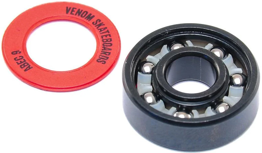 A black Venom ABEC 9 Skateboard Bearing next to a red rubber seal printed with “ABEC 9” and “SKATEBOARDS.”