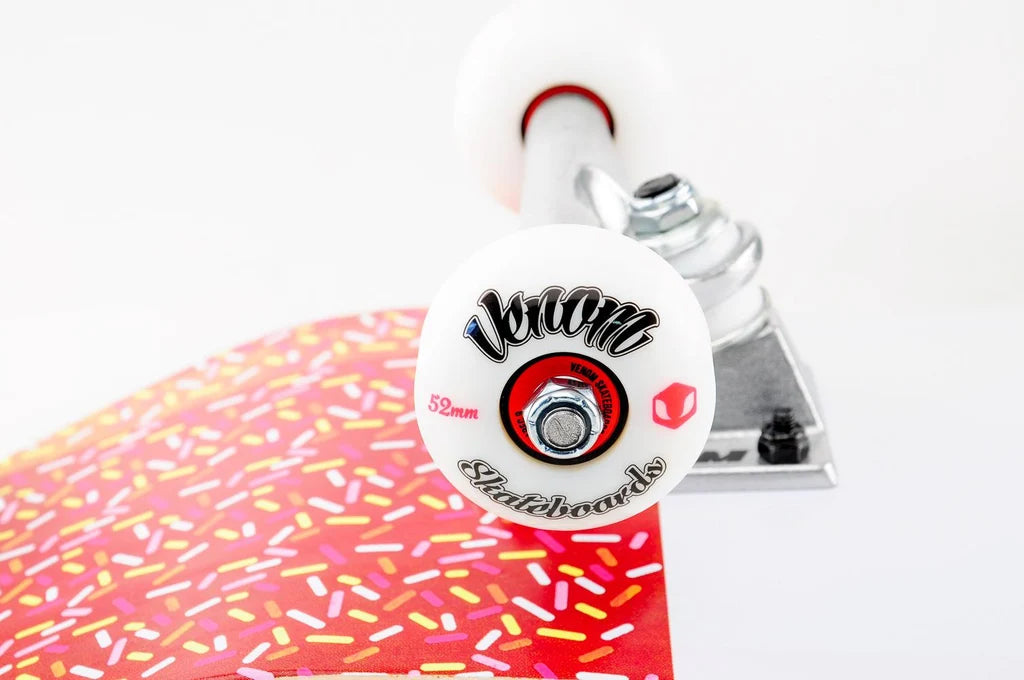 Venom Junior Ice Lolly Kids Complete Skateboard - 7.25″ x 29″ featuring white wheels and a deck patterned with colorful sprinkles.
