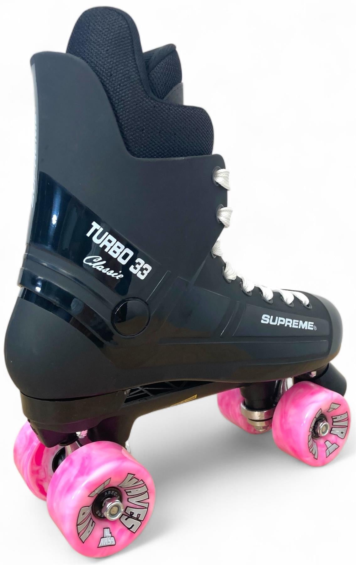The Supreme Turbo 33 Nylon Quad Roller Skates in black feature white laces and four pink swirl wheels, blending classic style with the quality of Supreme—perfect for roller skate enthusiasts.