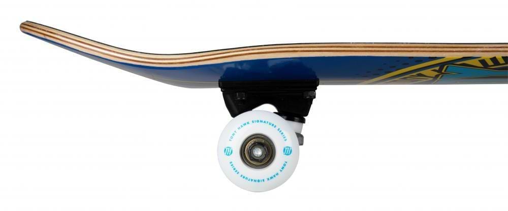 Side view of the Tony Hawk SS 180+ Badge Logo Blue / Yellow Complete Skateboard (7.5" x 31"), featuring a blue layered wood deck, black truck, white wheel with blue text, and a slightly elevated nose for beginners.