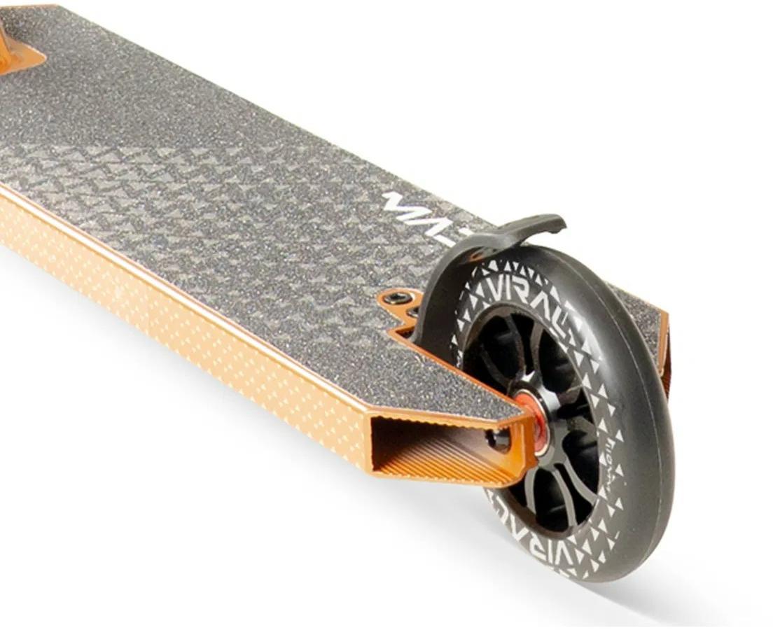 Close-up of the Madd Gear Viral KAOS Complete Stunt Scooter - Copper by MGP, featuring a textured deck, patterned rear wheel, and a small curved fender above the wheel.