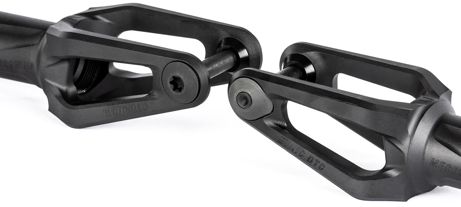 Close-up of two Ethic DTC Merrow V3 8/12STD SCS Stunt Scooter Forks in black, featuring open triangular designs and central bolts, positioned facing each other against a white background.