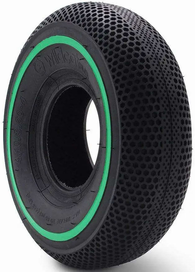 The Wildcat Original Pro 10" Mini BMX Tyre by Wildcat features a solid black design with a green sidewall strip and honeycomb pattern, offering durability and shock absorption for scooters or Wildcat Pro Mini BMX bikes.