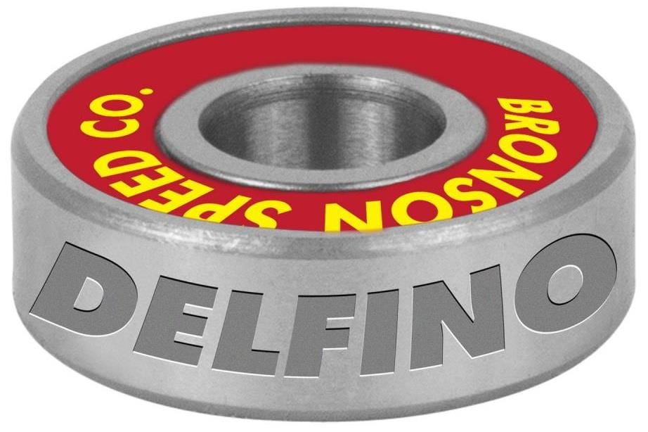 A silver skate bearing from Bronson with "DELFINO" engraved on the side, featuring a vibrant red center with yellow "BRONSON SPEED CO" text, from their popular Fabiana Delfino Pro G3 Skateboard Bearings - 8 Pack.