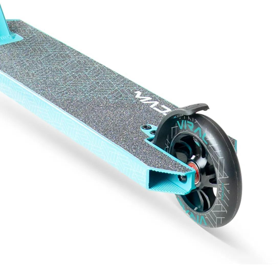 Close-up of the Madd Gear Viral Purge Complete Stunt Scooter - Aqua, showing the rear wheel, brake, and textured deck with geometric patterns and a partial MGP logo.