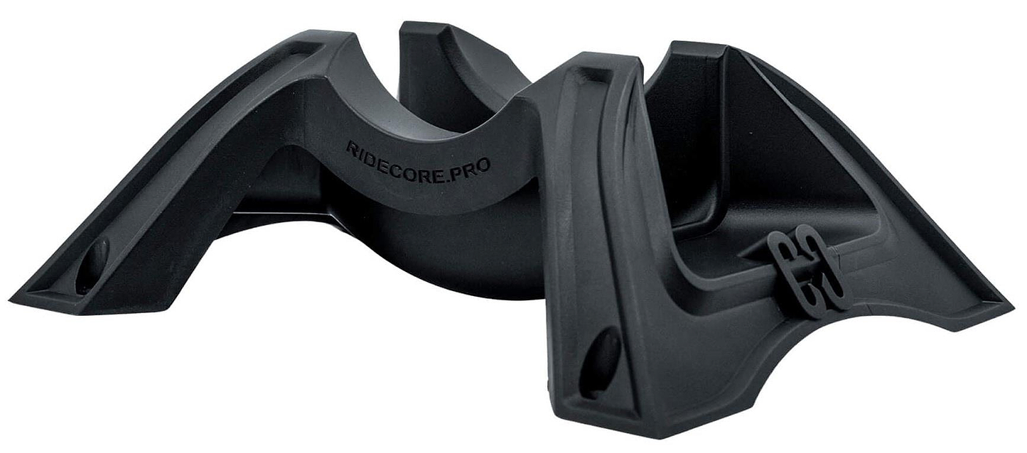 The CORE Claw Scooter Floor Stand - Black by CORE is an angled black plastic support stand with curved grooves and a sturdy, elevated design, ideal for securely holding scooters.