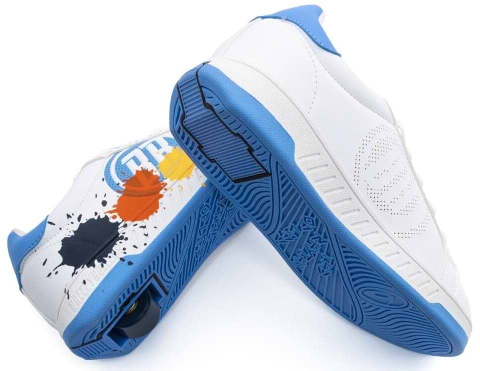 The Breezy Rollers Splash Shoes in White/Light Blue feature a patented heel wheel on one shoe and colorful paint splatter designs in black, orange, yellow, and blue on the other. Brand: Breezy Rollers.