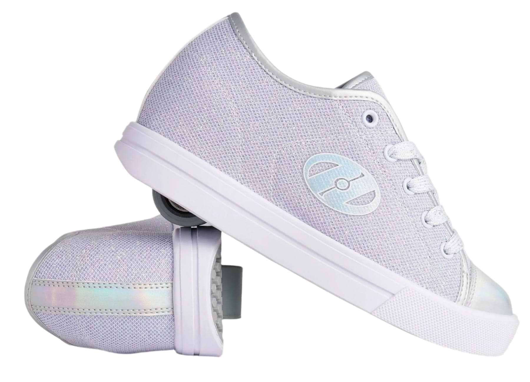 A pair of Heelys Classic Em Girls Shoes in silver, white, and grey; one stands upright while the other lies on its side, displaying a retractable wheel with ABEC 3 bearings. Features metallic details, mesh upper, and a circular logo on the side.