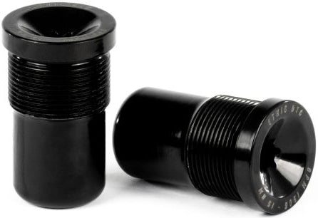 Two black cylindrical metal objects with threaded midsections are displayed—one upright, the other lying horizontally to reveal engraved text on its flat end. Both feature a flared rim and a glossy, smooth finish. These Ethic DTC Handlebar Balance Point Modulation - 150g bar ends by Ethic are expertly crafted to provide riders with exceptional durability and precise balance point modulation.