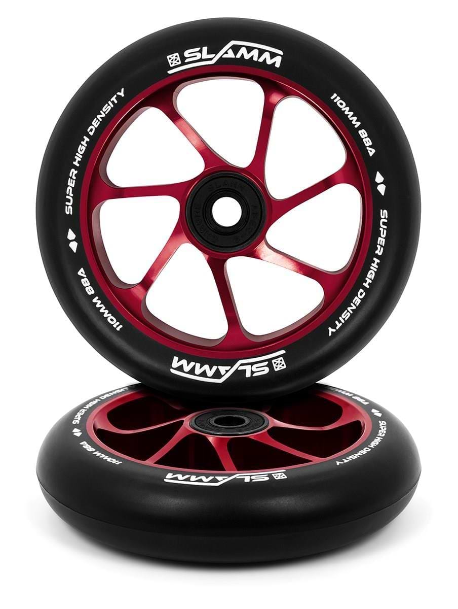 A pair of Slamm Team 110mm stunt scooter wheels in red, featuring a high-rebound PU construction with white lettering. The specifications are "110mm 88A Super High Density." One wheel stands upright while the other leans against it.