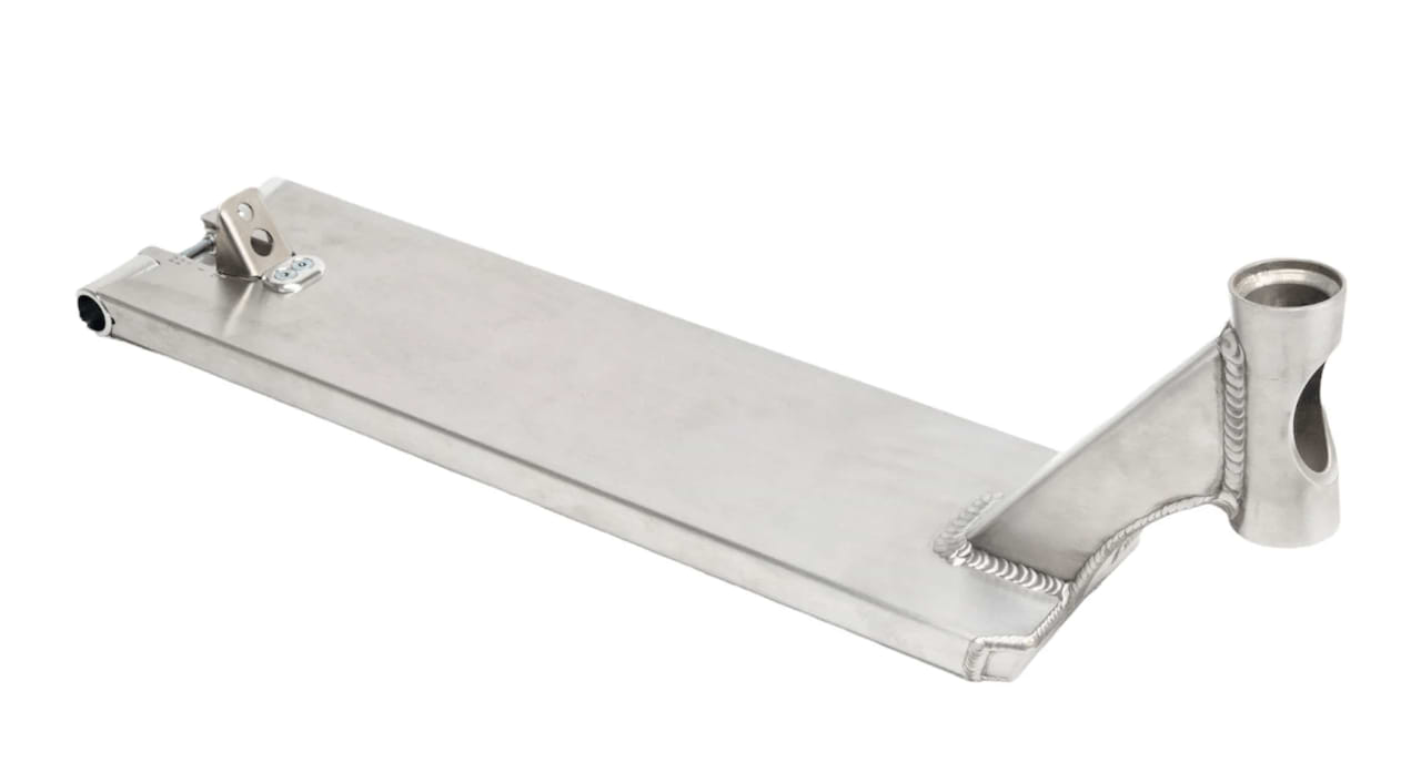 This robust scooter deck, identified as the Apex Pro Raw Silver Boxed Stunt Scooter Deck - 6" x 22", is expertly crafted by Apex from silver metal, showcasing precise welding and a smooth finish. It features a flat rectangular base with a circular cutout at one end and a bracket situated near the top, offering a design that is both sleek and practical.