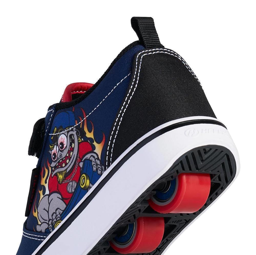 A close-up of the heel of Heelys Pro 20 Prints X2 Boys Shoes by Heelys in navy and red, featuring colorful cartoon robot artwork with flames and red wheels—fun boys shoes with wheels for style and play.