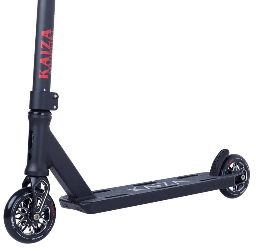 The image shows the Longway Kaiza Complete Pro Stunt Scooter in black, with a sleek deck, black wheels featuring silver spokes, and "Longway" branding on both the stem and deck. It’s a side view focused on the lower half of this ideal skatepark scooter.