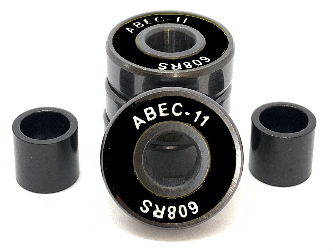 A set of four Logic ABEC 11 Black Scooter Bearings is shown, with one bearing turned to display its label. These high-performance bearings, from the brand Logic, include two cylindrical spacers positioned on each side against a white background, emphasizing their speed capabilities.