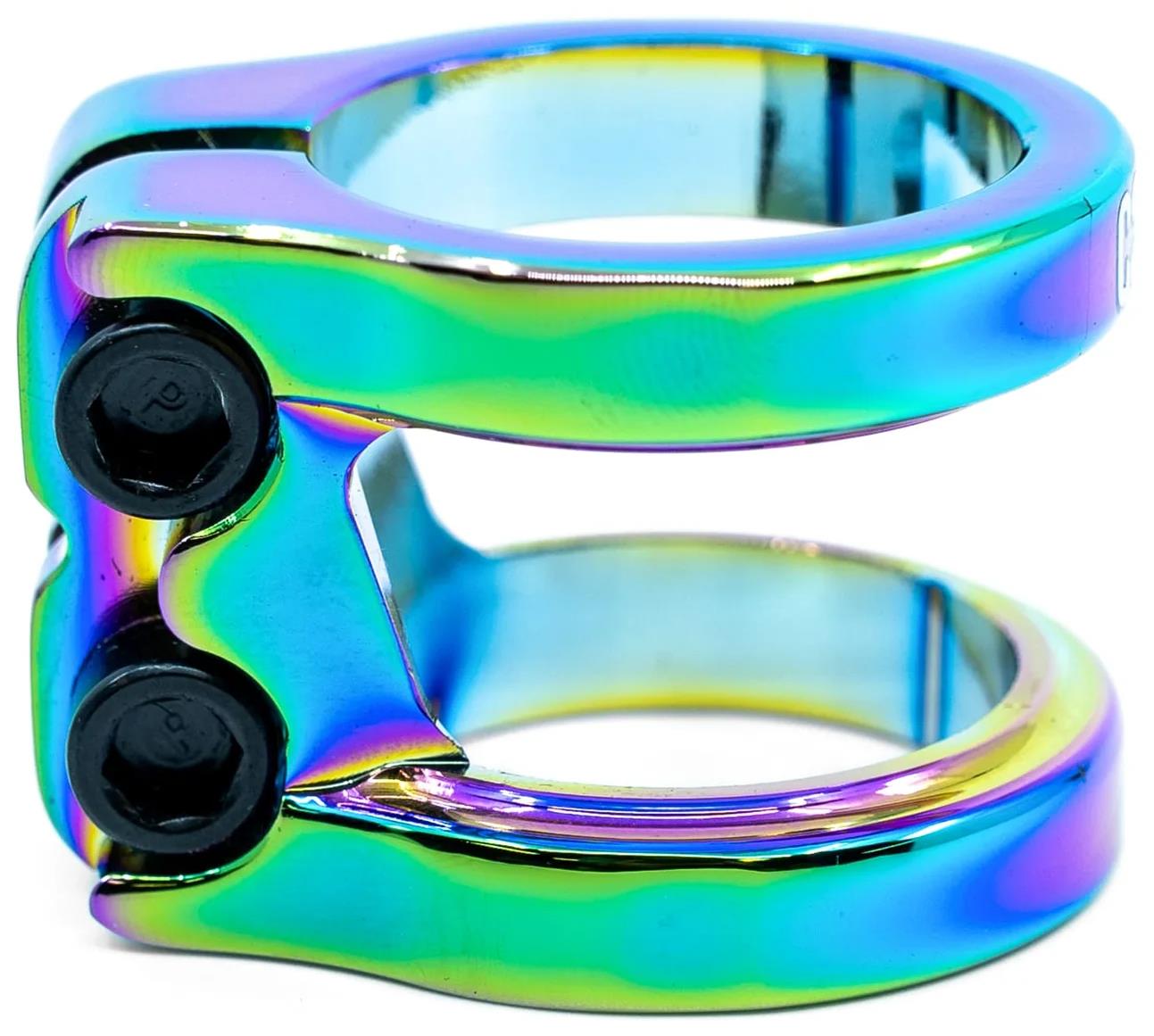 The CORE Venom 2 Bolt Oversized Stunt Scooter Clamp by CORE features a neochrome metallic finish with blue, green, and purple hues, two black screws, and an oversized double clamp design with a shiny, reflective surface.