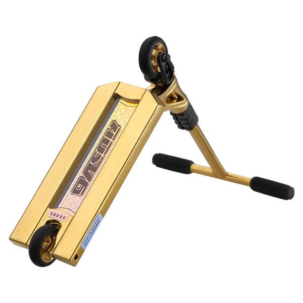 The Blunt Envy AOS V6 Finger Scooter in gold features black handle grips, a wide deck, and black wheels, shown angled to display both deck and handlebars. Ideal for fans of Blunt Envy's AOS V6 design.