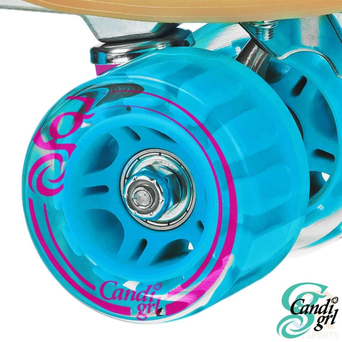 A vibrant blue roller skate wheel with pink accents, mounted on a metal axle, makes these Candi Girl Carlin Women's Quad Roller Skates ideal for artistic skating. The transparent texture elegantly highlights the "Candi Grl" brand in a decorative font, perfect for outdoor adventures.