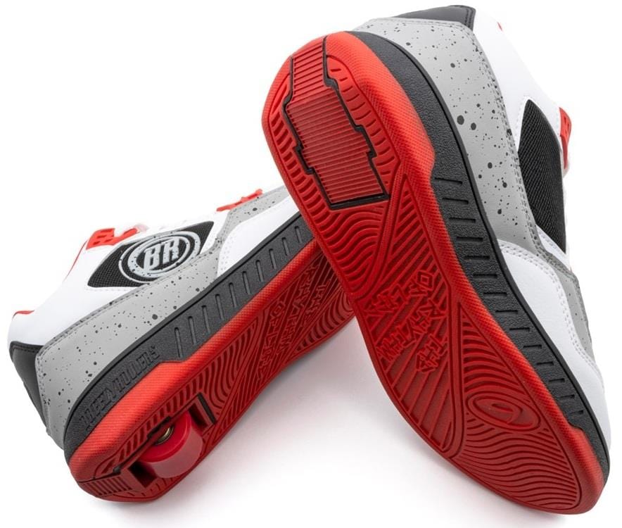 Breezy Rollers Jumper Shoes in White/Grey/Red by Breezy Rollers feature a speckled gray design, circular logo, red soles, and a patented heel wheel system for smooth gliding. One shoe is tilted to show the innovative wheel.