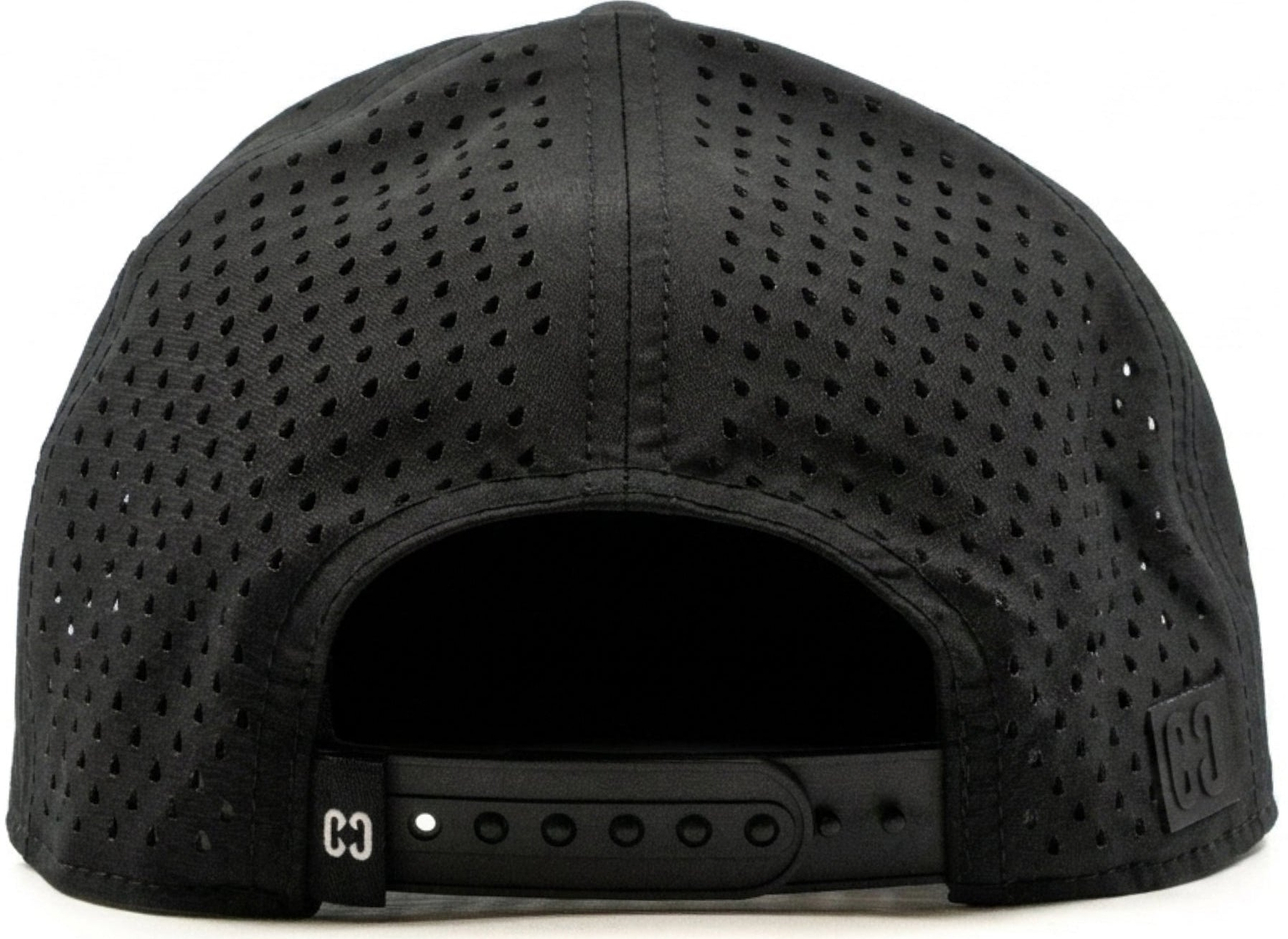 The CORE Aero Rope Cap - Black is shown from the back, highlighting its black perforated snapback design with an adjustable strap featuring holes and a small CORE logo tag on the left side.