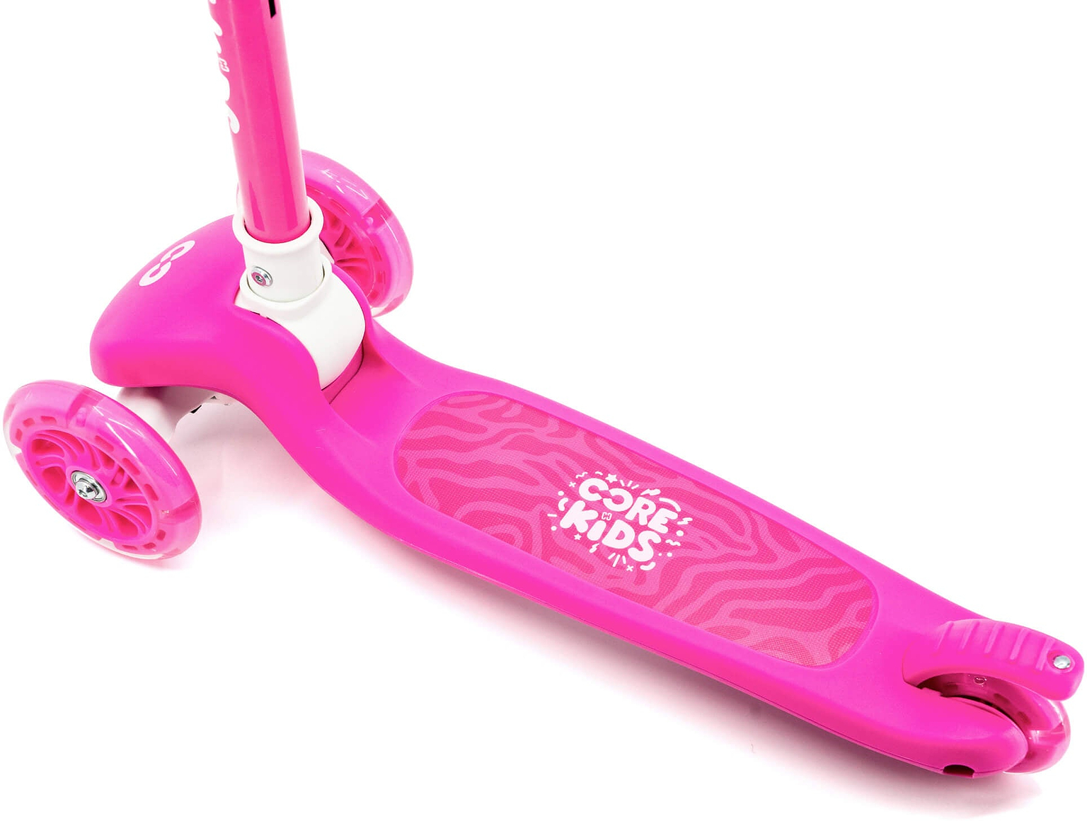 A close-up of the CORE Foldy 3 Wheel Kids Scooter in pink, featuring “CORE KIDS” branding on its textured foot deck. This lean-to-steer scooter by CORE has two front wheels and one rear wheel, providing young riders with both stability and fun.