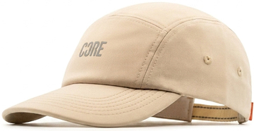 The CORE Performance Cap by CORE features “CORE” in reflective gray lettering on the front, crafted from breathable fabric in a sand color with detailed stitching and an adjustable strap at the back.