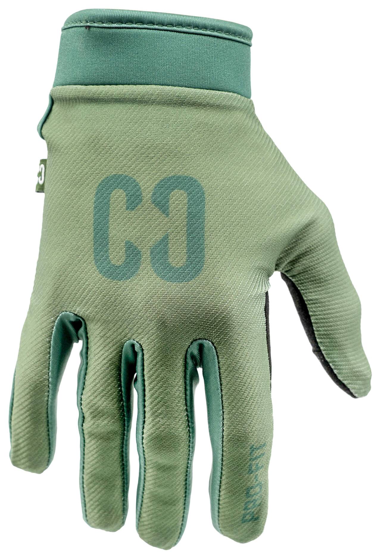 A CORE Pro-Fit Velcro Skate Protection Glove in Army Green, featuring a teal “CO” logo on the back of the hand, is shown with the palm facing away and fingers slightly bent.