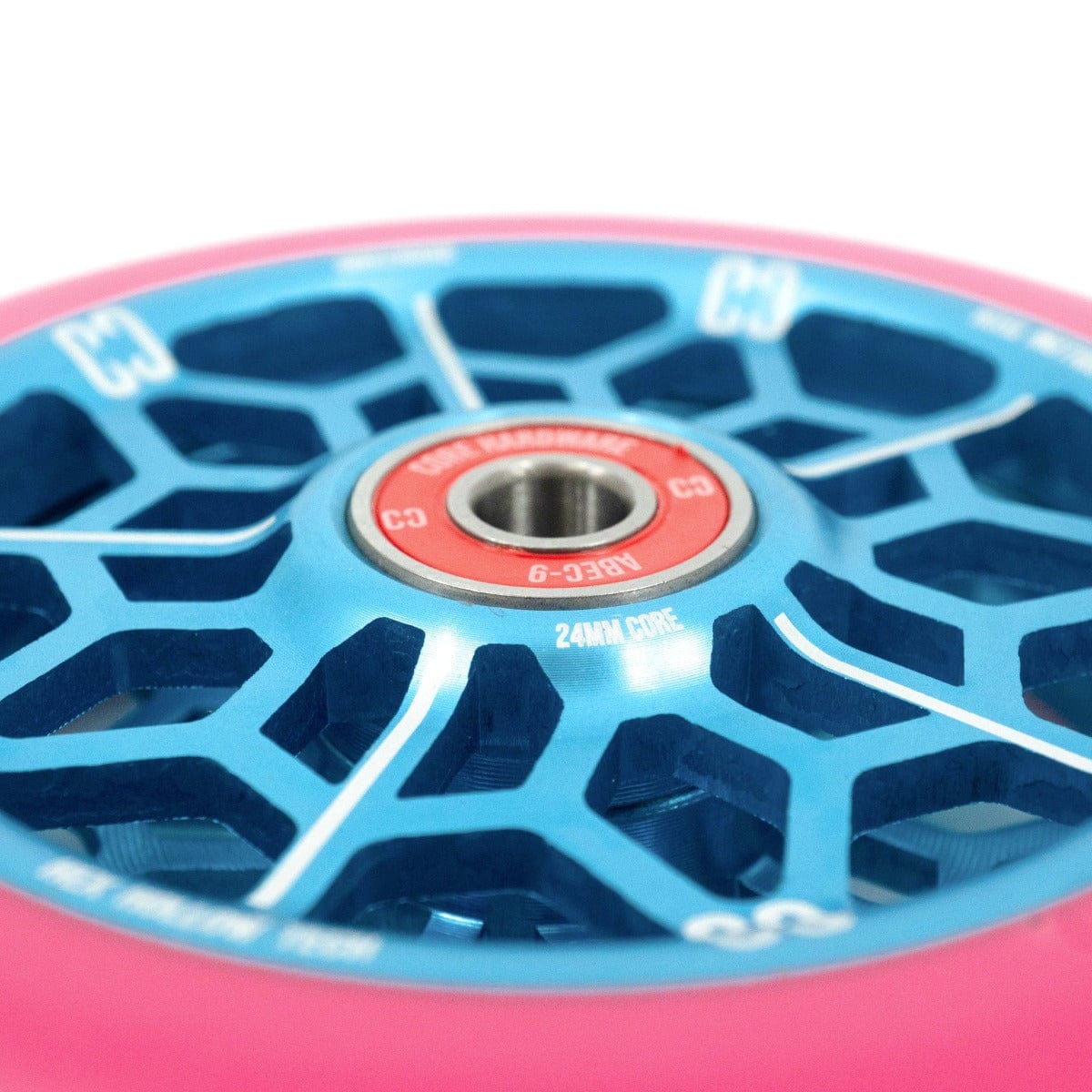 Close-up of the CORE Hex Hollow Core 110mm Stunt Scooter Wheel in vibrant pink and blue, showcasing an intricate spoked design. The center features a red and silver ABEC-9 bearing labeled "C3." The dynamic colors combined with the 88a compound make it ideal for skateboards or scooters.