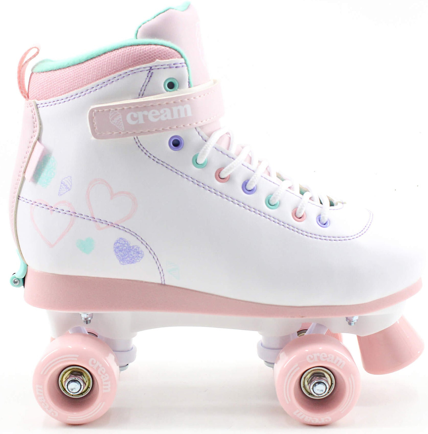 The CREAM Scoop Hearts Adjustable Quad Roller Skates in white and pink feature pastel-colored laces, heart designs on the side, and "CREAM" branding on the ankle strap. Made from vegan leather, these beginner-friendly skates offer a charming look with pastel pink wheels and a matching sole.