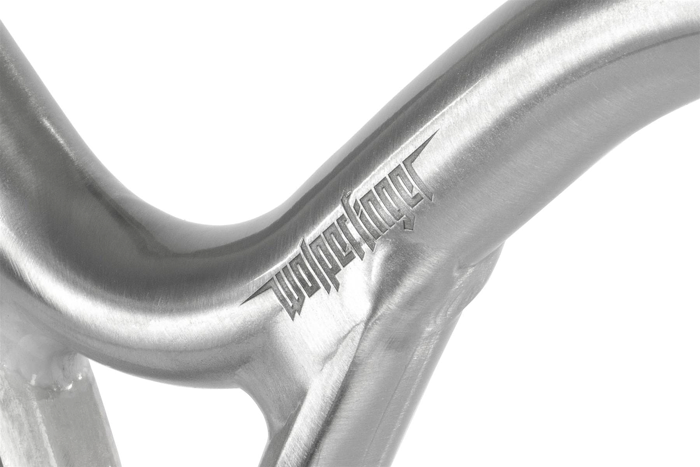 Close-up of Ethic DTC Wolpertinger Aluminium IHC Stunt Scooter Bars in raw silver (670mm x 560mm), showing the engraved “Wolpertinger” name on its smooth, curved surface—reflecting high-end stunt scooter craftsmanship.