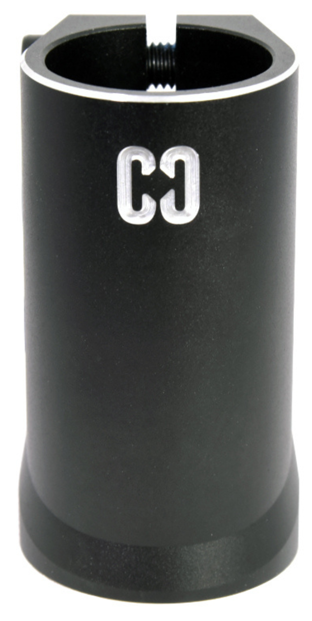 The CORE Aura 4 Bolt Oversized SCS Stunt Scooter Clamp by CORE is a black cylindrical aluminum clamp with a top slot and "CG" engraved in white on the front.